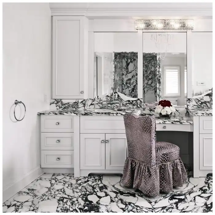 Arabescato-Corchia-honed-finish-sample-beside-a-polished-sample-under-raking-light-on-the-same-slab