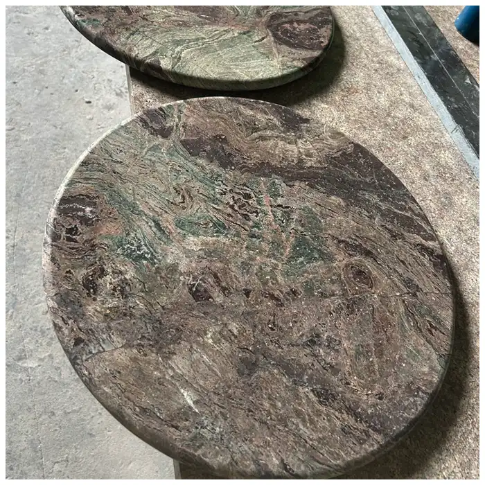 Close view of leathered Nebula Breccia round coffee-table surface and edge